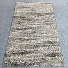 Abstract striped area rug with cream field and dark gray flecked horizontal lines