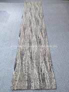 Extra-long abstract runner rug with distressed wavy stripes, gray and cream tones