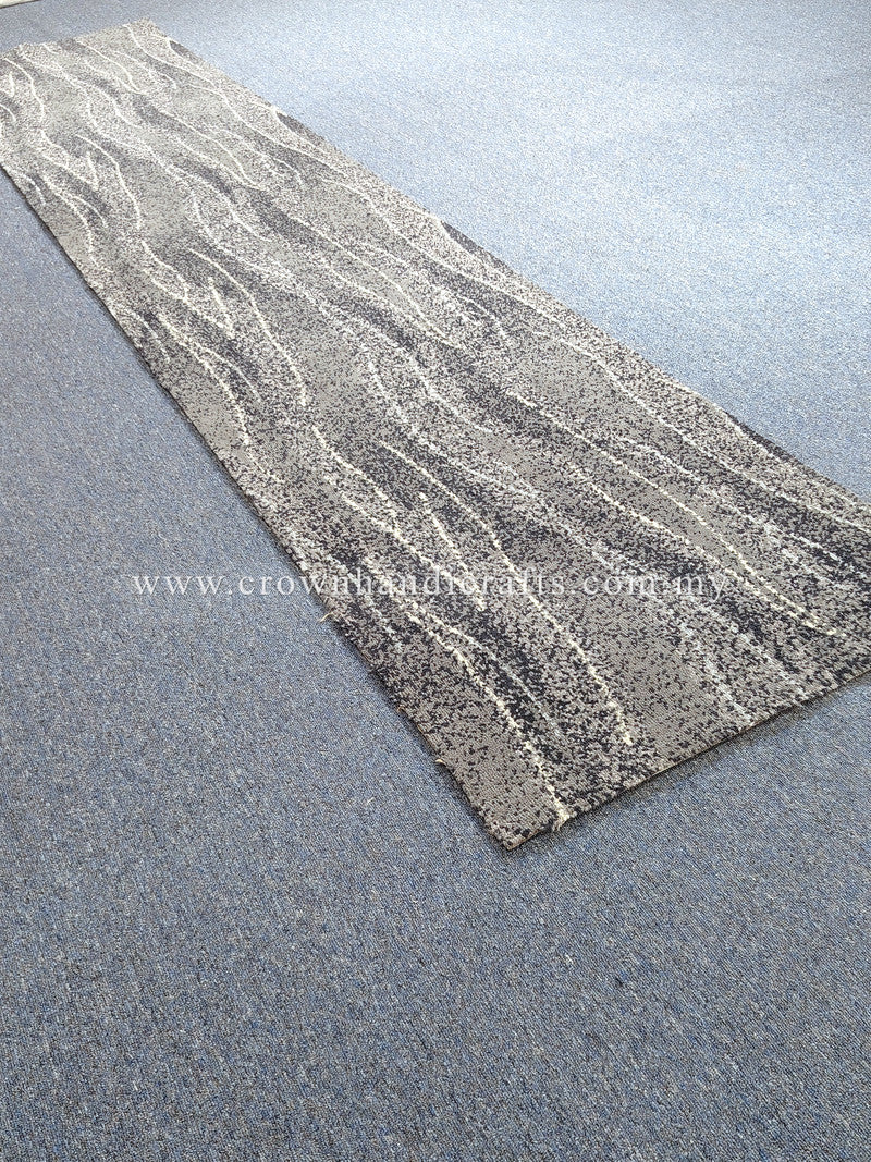 Extra-long abstract runner rug laid on surface, gray and cream wavy stripe pattern
