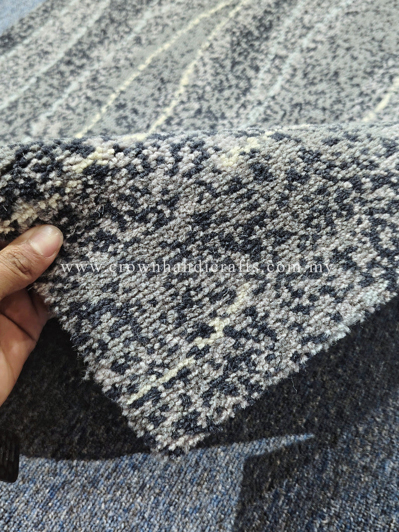 Abstract runner rug with charcoal and cream speckled pile, close-up corner and edge