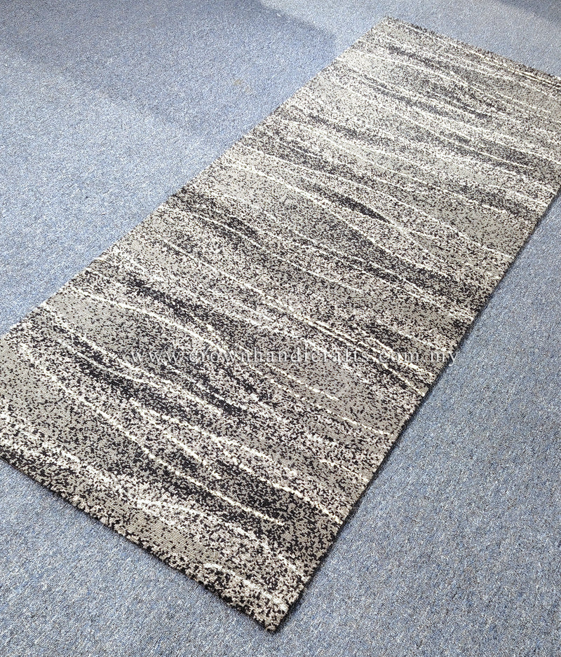 Abstract runner rug with beige base and dark speckled stripe lines, angled view