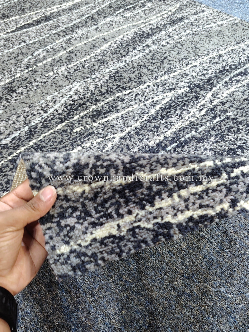 Abstract runner rug close-up: cream and dark speckled stripe pattern with folded edge
