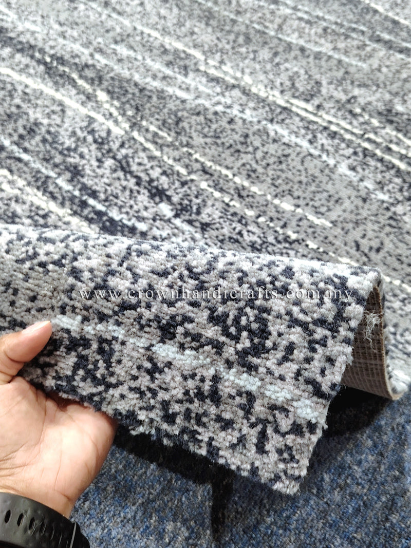 Abstract runner rug with speckled black-and-cream pattern, folded edge detail