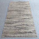 Runner rug with dense speckled texture and light-to-dark striped pattern, full view