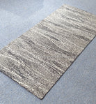 Runner rug with horizontal micro-stripes and speckled pattern in neutral gray tones