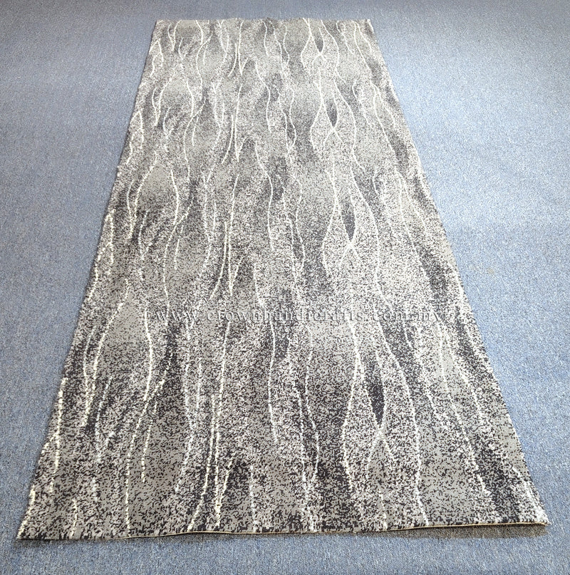 Abstract floor rug, light beige with white flowing line pattern and stitched border.