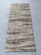 Beige and dark abstract runner rug with horizontal striped texture, full view