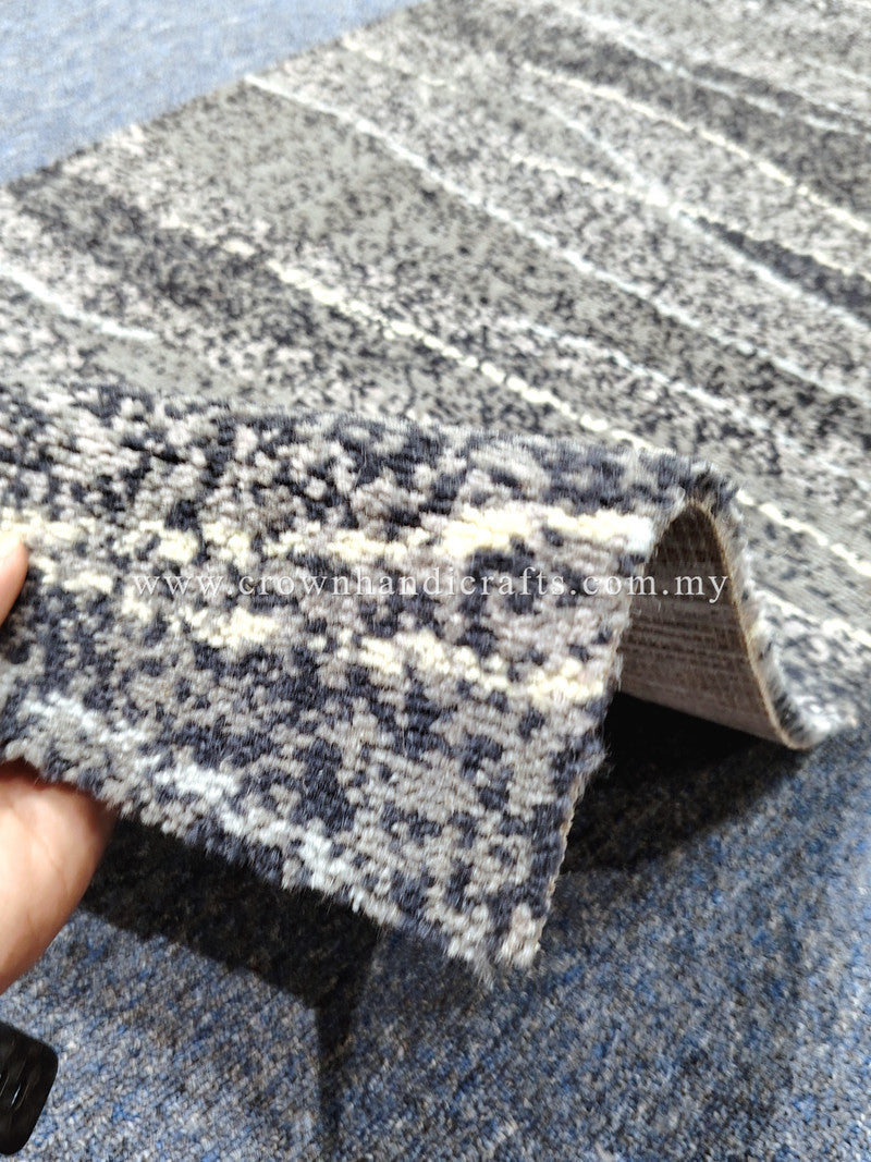 Dark blue and cream speckled runner rug, close-up lifted edge with backing visible