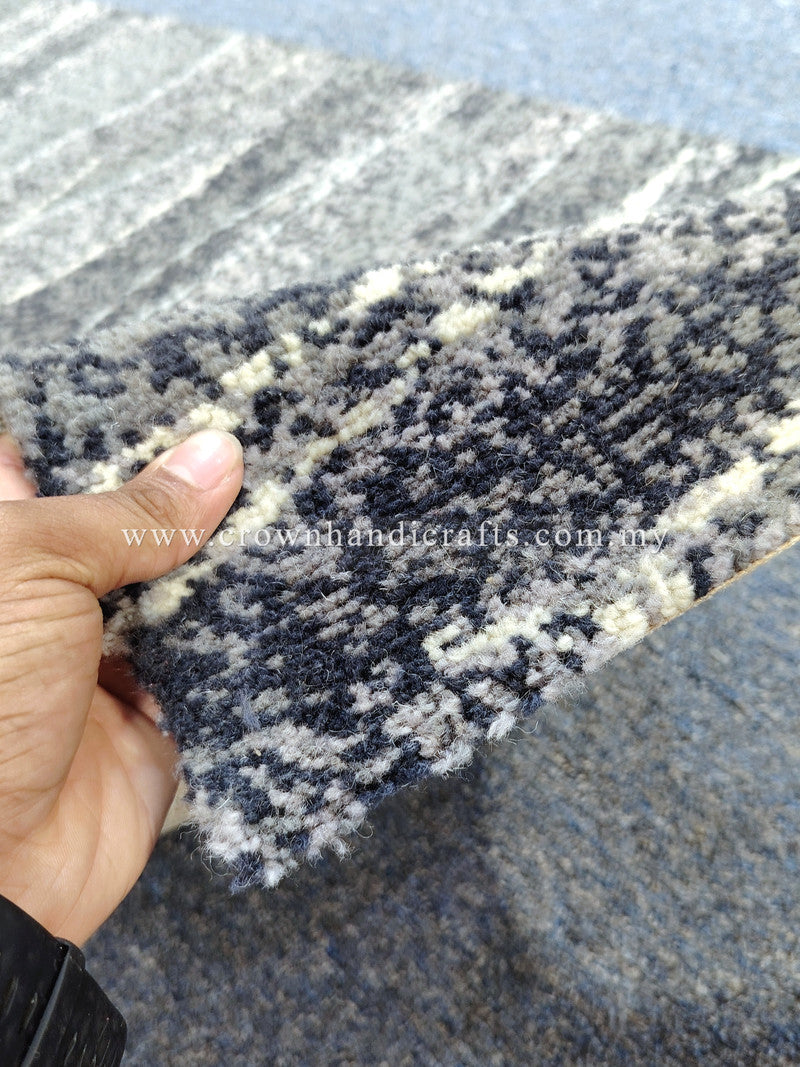 Flecked navy and cream abstract runner rug, close-up corner and stitched edge
