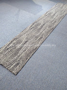 Long abstract runner rug with light gray base and white wavy line pattern