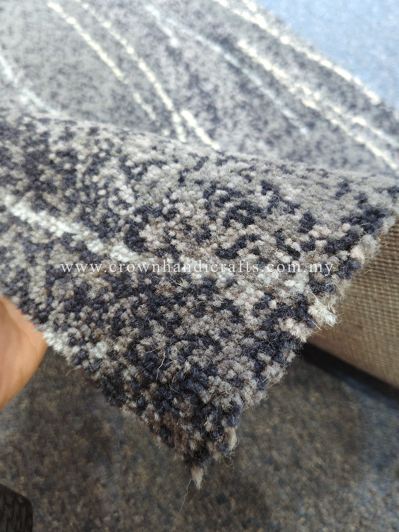 Runner rug corner close-up with dense dark blue-gray and light speckled motif