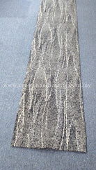 Long runner rug with vertical wavy white streak pattern on light gray base