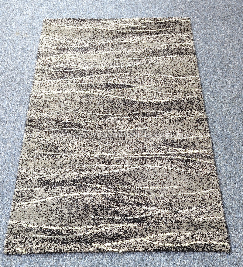 Abstract area rug with cream and black speckled stripe pattern, rectangular flat lay