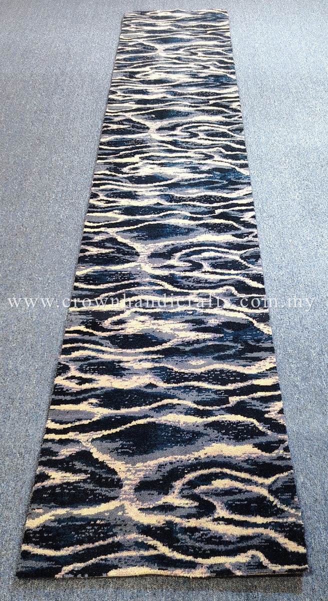 Rectangular runner rug with bold zebra wave pattern in navy and cream on light gray