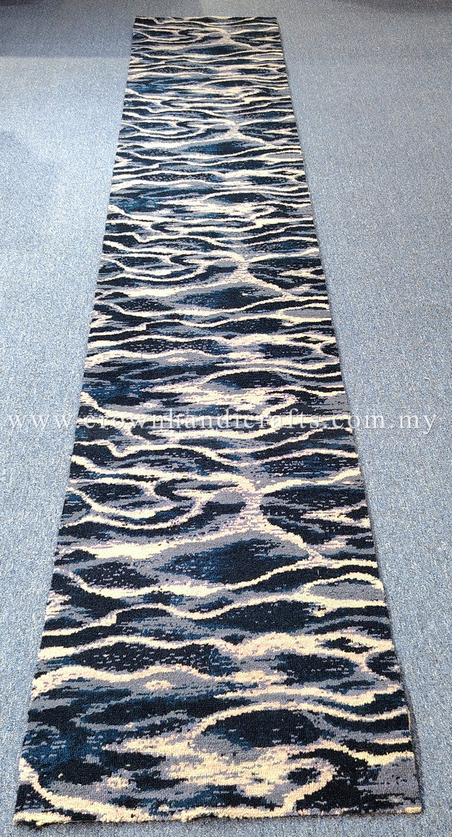 Long runner rug with wavy animal pattern, navy and cream bands on light gray