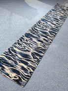 Wave-pattern runner rug with dark navy edge and cream wavy lines on light gray