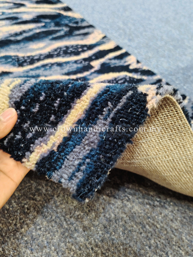 Folded wave-pattern runner rug showing jute backing, navy and cream stripe design