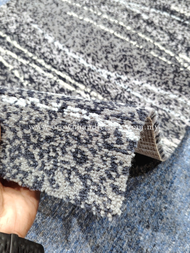 Close-up of abstract rug pile with mottled speckle and striped texture, gray tones