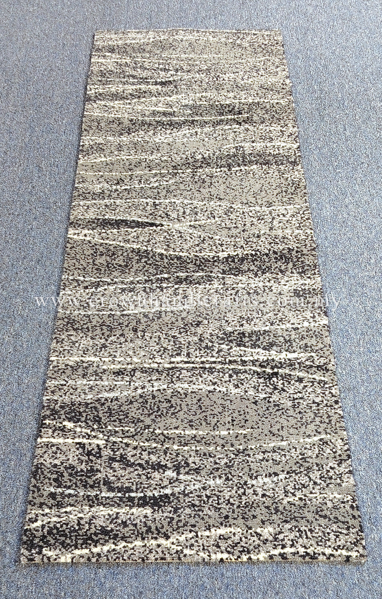 Hallway runner rug with beige and black speckled abstract horizontal stripe pattern