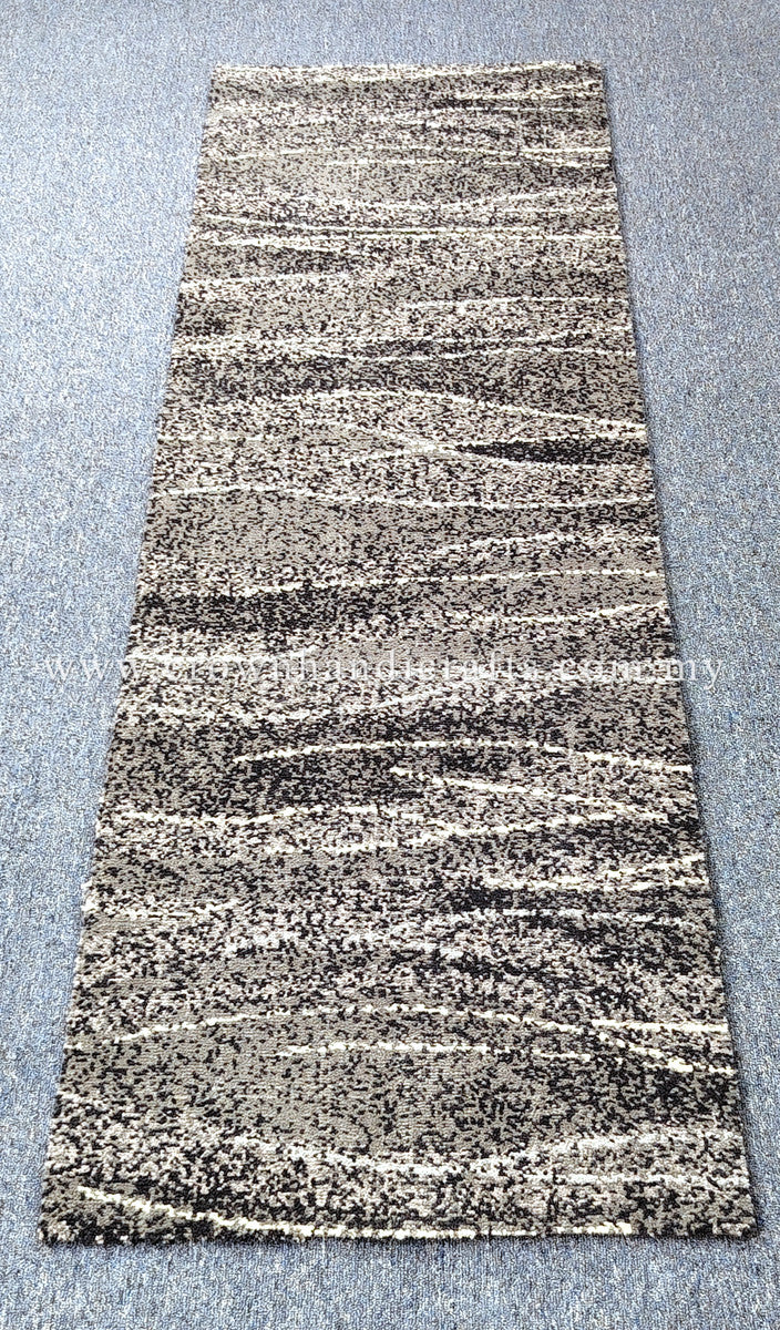 Hallway runner rug in beige and dark speckled abstract stripes with short, dense border