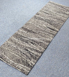 Hallway runner rug angled view with beige base and black-and-white speckled horizontal lines