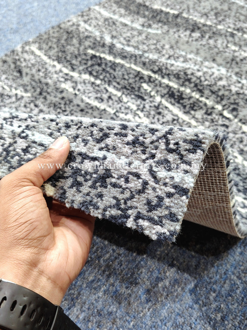 Hallway runner rug close-up showing speckled abstract stripes and stitched edge with backing