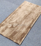 Beige-brown runner rug with shimmering textured weave and flat bound edges