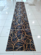 Dark blue runner rug with gold and light-blue ornate swirl vine pattern, standing full length
