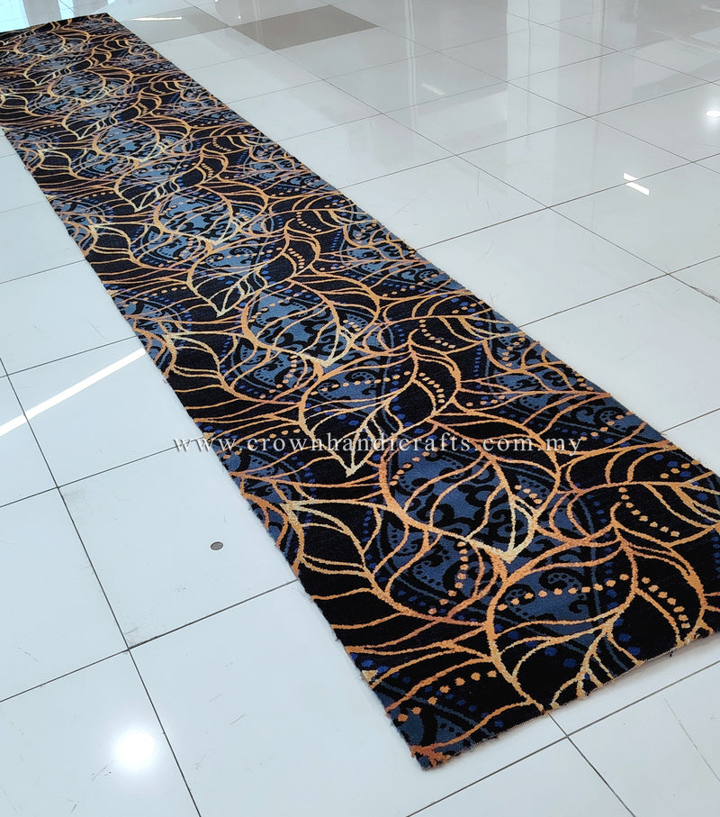 Navy blue runner rug with gold and light-blue swirling vine pattern, long hallway view