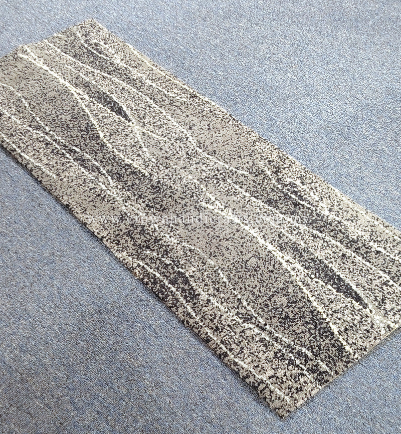 Abstract patterned hallway runner rug laid diagonally, speckled gray and white lines