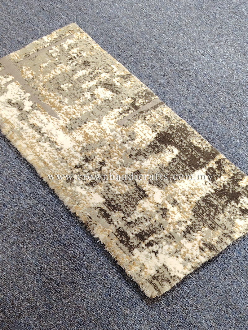 Compact grey mat rug laid flat, beige and dark distressed geometric pattern