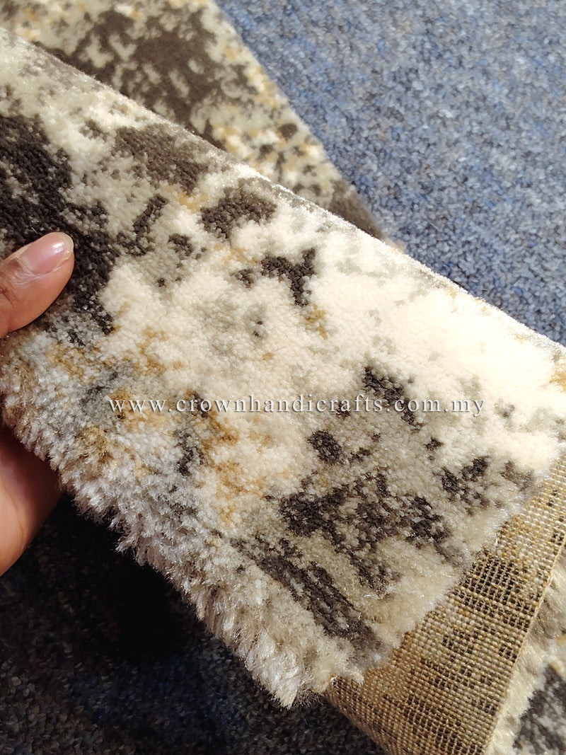 Compact grey mat rug texture close-up, beige pile with dark abstract pattern