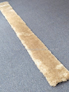 Beige ultra-slim shag runner rug laid flat, narrow long hallway style