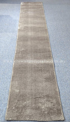 Hallway runner rug in beige with low-pile texture and darker shaded ends