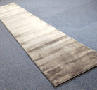 Hallway runner rug angled view, light beige with soft horizontal shading and low pile