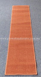 Rust velvet runner rug, long narrow design with consistent plush pile