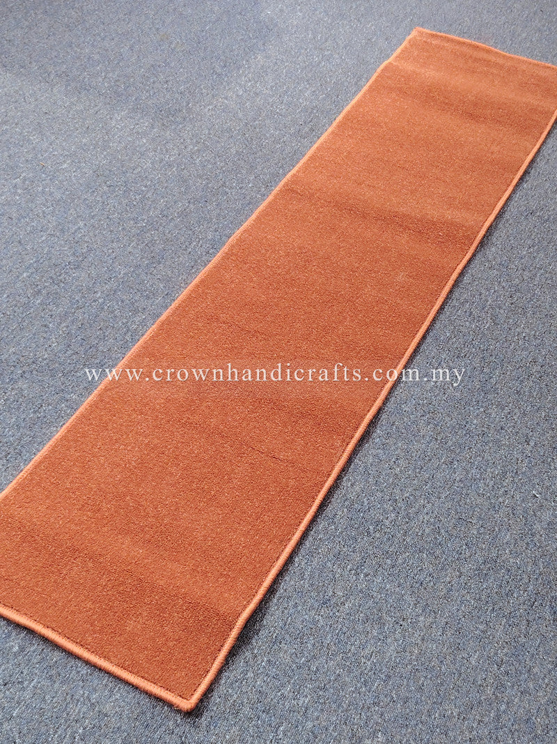 Rust velvet runner rug with flat border and narrow rectangular shape