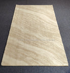 Cream area rug with soft abstract linear texture and even flat woven pile