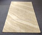 Cream area rug with light abstract stripes and smooth low pile surface