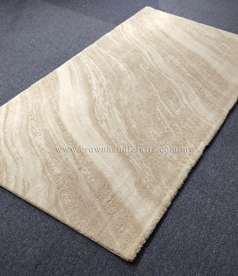 Cream area rug with subtle wavy stripe pattern in low pile