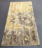 Hallway runner rug with grey and yellow abstract speckle design and flat, textured surface