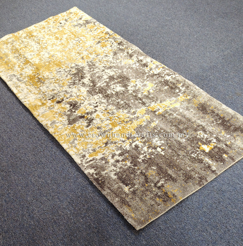 Hallway runner rug laid flat, distressed grey, white, and yellow abstract pattern