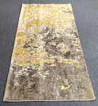 Two-tone runner rug with grey and yellow abstract distressed pattern, wide top view