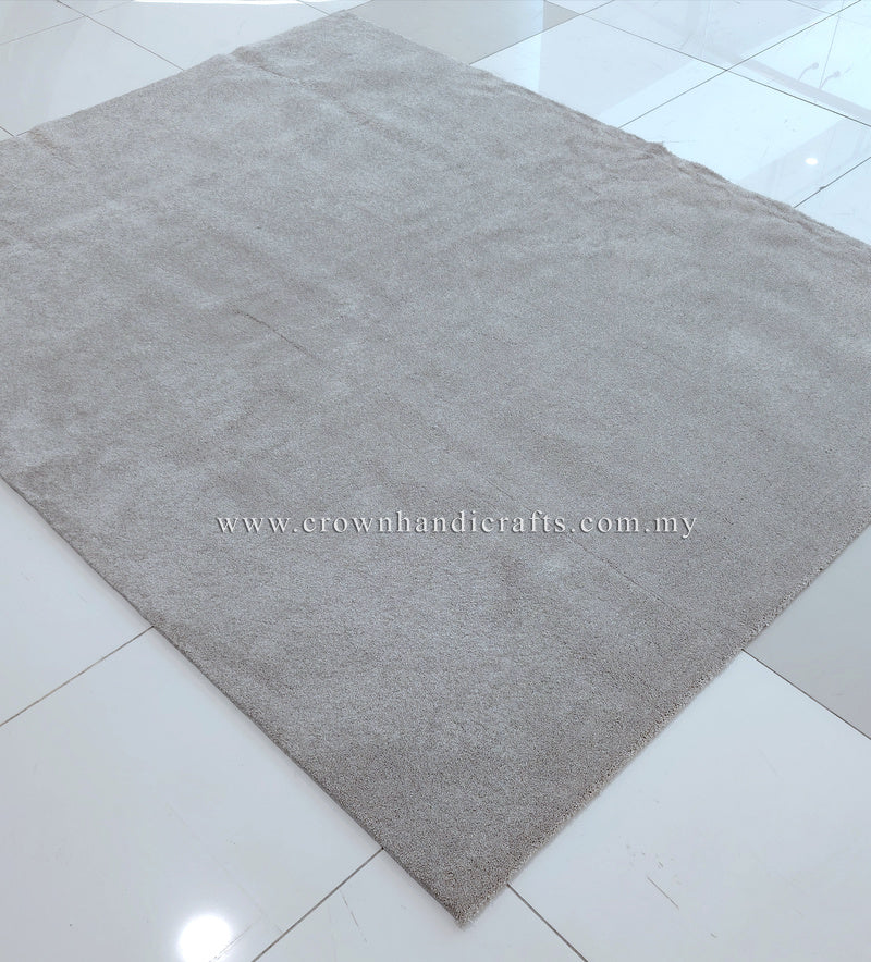 Plush area rug with uniform short pile in light gray-beige on smooth floor