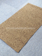 Brown textured door mat rug with low pile and neat flat edges