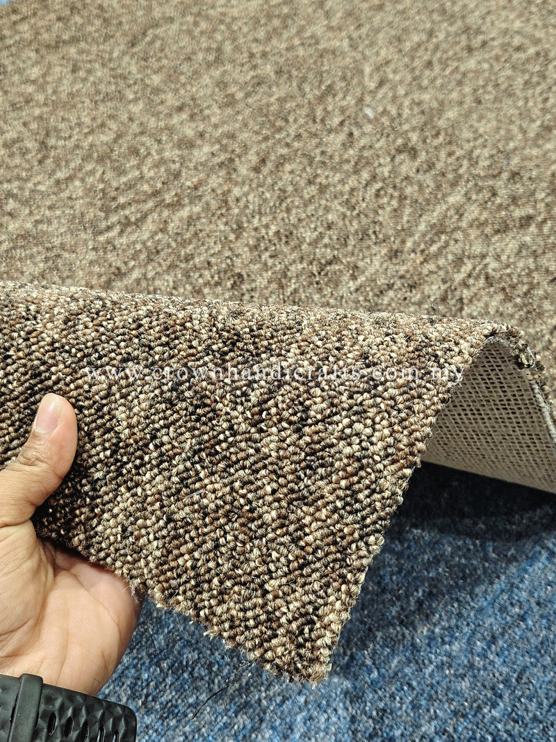 Brown rug edge held up to show woven texture and tan backing underside
