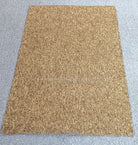 Rectangular brown-tan area rug, uniform textured surface with straight stitched border