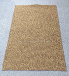 Rectangular brown-tan rug with dense speckled pile, viewed from above