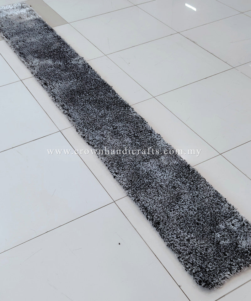 Black-and-white shag runner rug with dense texture, angled view.