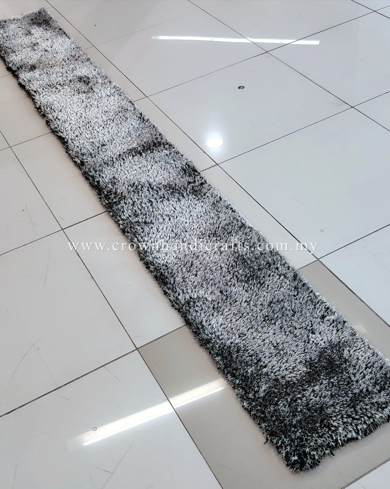 Thin black-and-white shag runner rug with speckled high-pile texture.